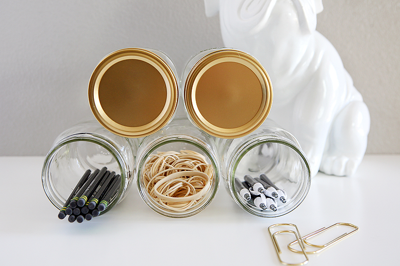 https://eighteen25.com/wp-content/uploads/2015/12/mason-jar-organizer-gold-lids.jpg